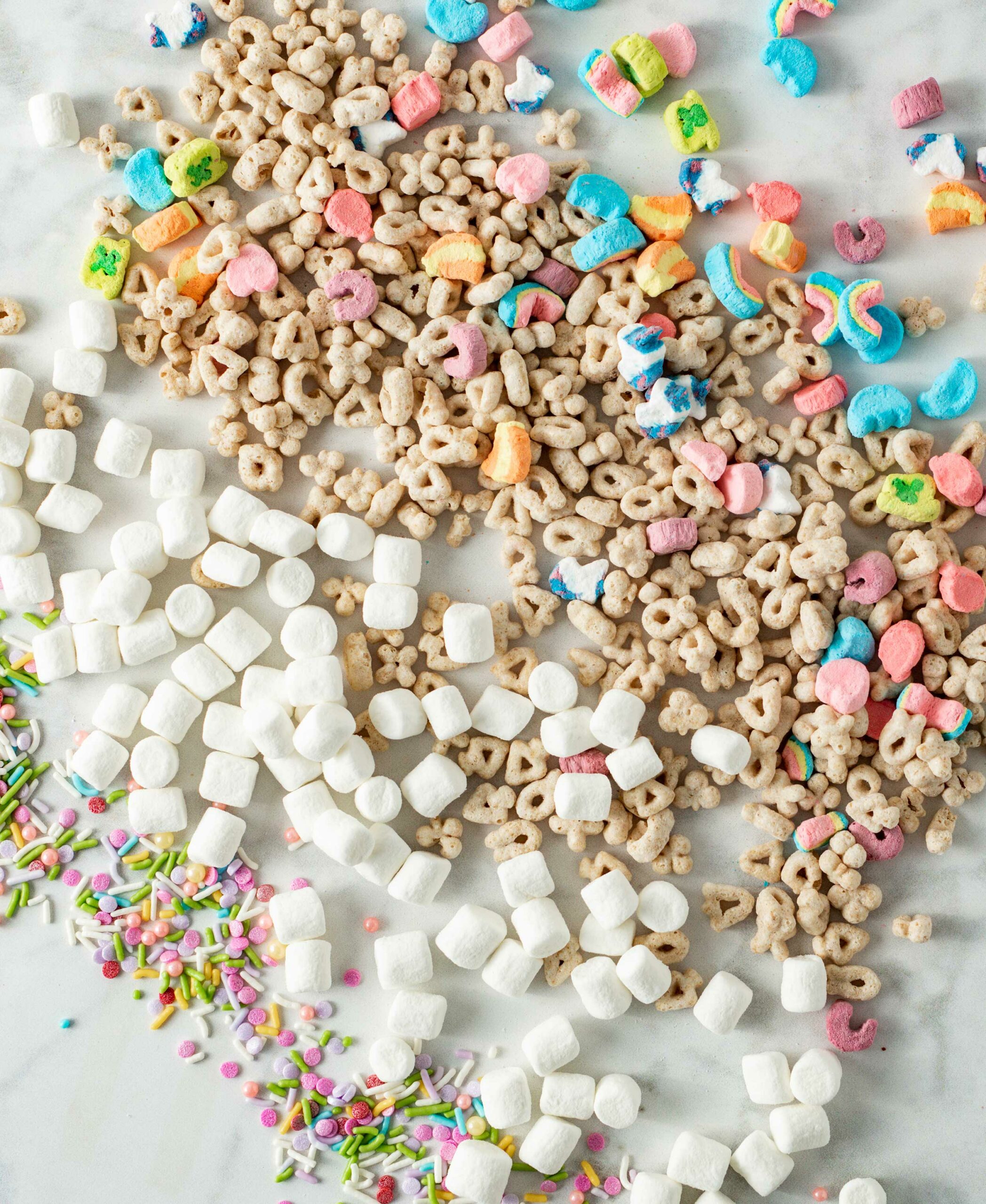Ingredients for Lucky Charms Marshmallow Crispy Treats spread out on table