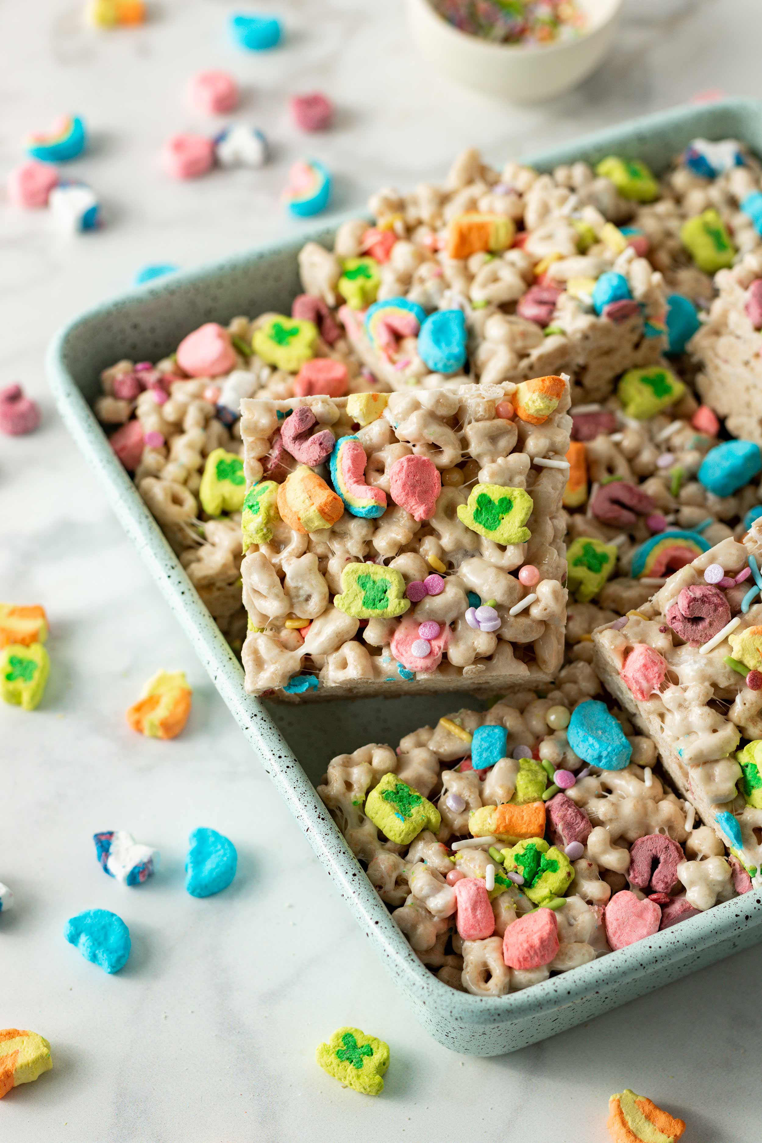 Lucky Charms Marshmallow Crispy Treats cut into squares in 9x9 baking tray