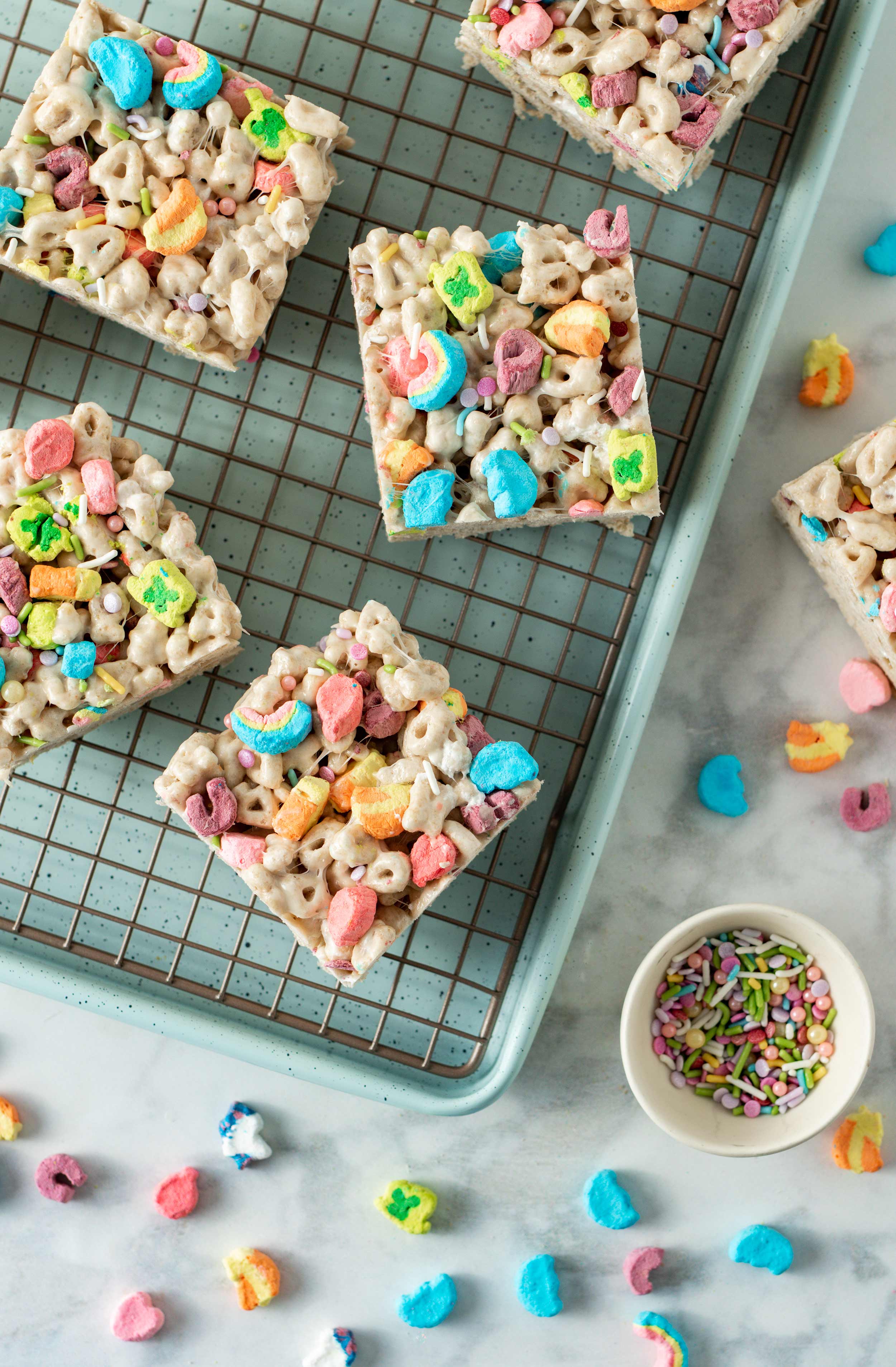 Lucky Charms Marshmallow Crispy Treats cut into squares on baking cooling rack