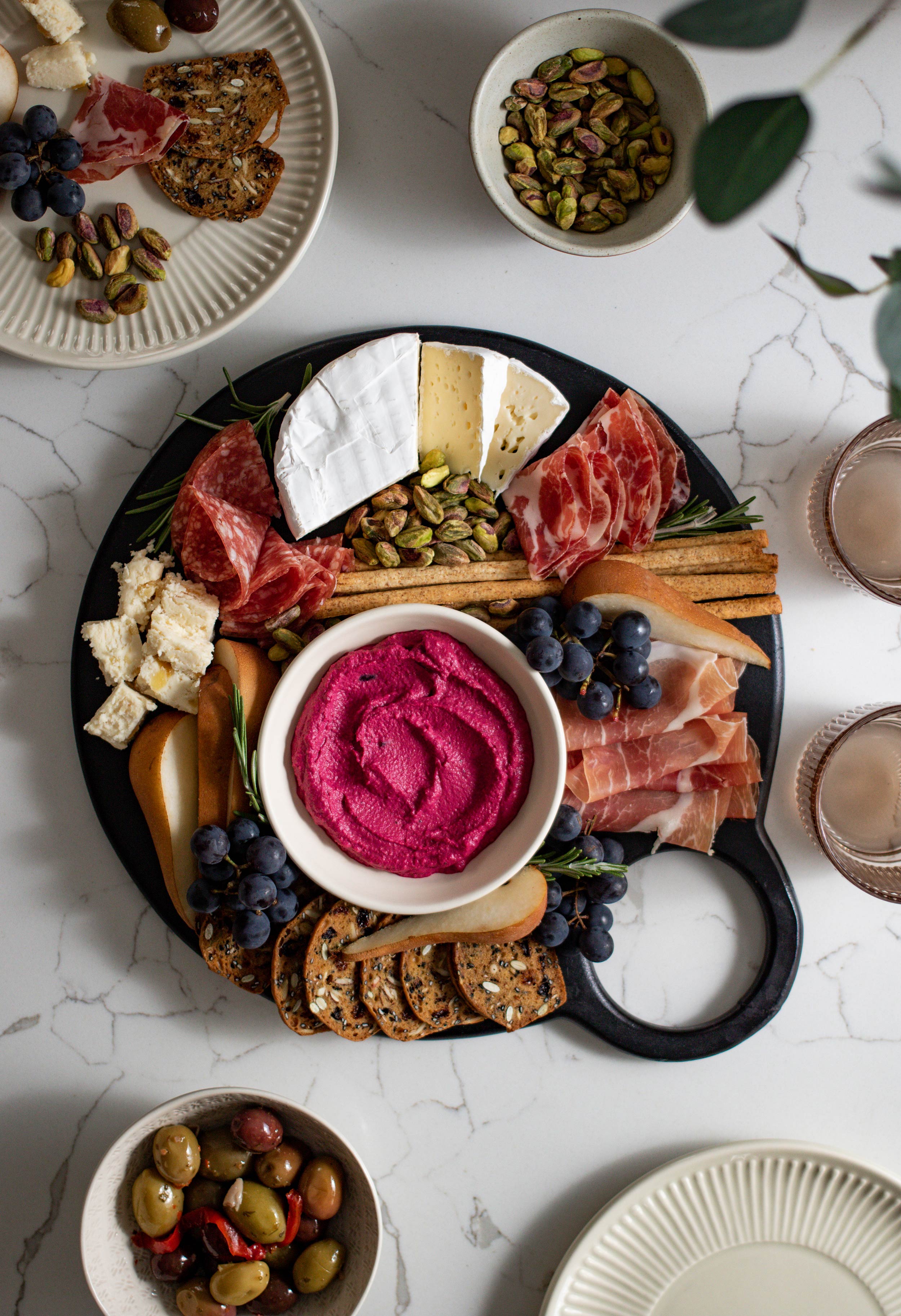 Thanksgiving charcuterie board with cheese, meat, fruit and hummus